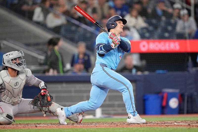 Apr 30, 2025; Toronto, Ontario, CAN; Toronto Blue Jays center fielder Dalton Varsho (5) hits a two-run home run against the Boston Red Sox during the sixth inning at Rogers Centre. Mandatory Credit: John E. Sokolowski-Imagn Images