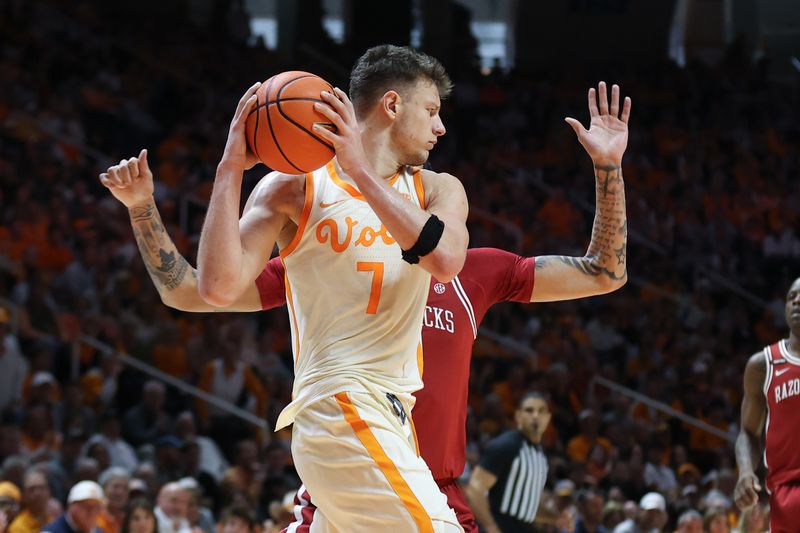 Jan 4, 2025; Knoxville, Tennessee, USA; Tennessee Volunteers forward Igor Milicic Jr. (7) rebounds the ball against the Arkansas Razorbacks during the second half at Thompson-Boling Arena at Food City Center. Mandatory Credit: Randy Sartin-Imagn Images