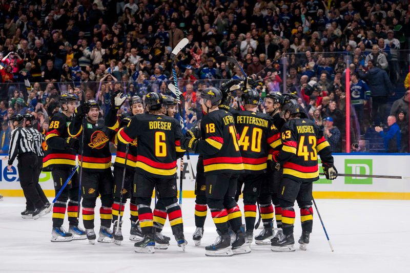 Jan 27, 2024; Vancouver, British Columbia, CAN; The Vancouver Canucks celebrate their victory against the Columbus Blue Jackets at Rogers Arena. Canucks won 5-4 in overtime. Mandatory Credit: Bob Frid-USA TODAY Sports