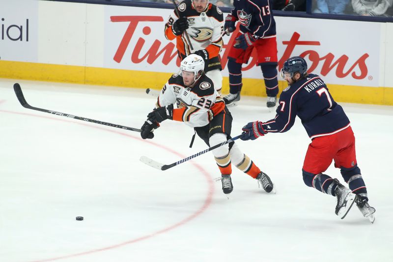 Oct 24, 2023; Columbus, Ohio, USA; Anaheim Ducks center Mason McTavish (23) steals the puck from Columbus Blue Jackets center Sean Kuraly (7) during the third period at Nationwide Arena. Mandatory Credit: Joseph Maiorana-USA TODAY Sports