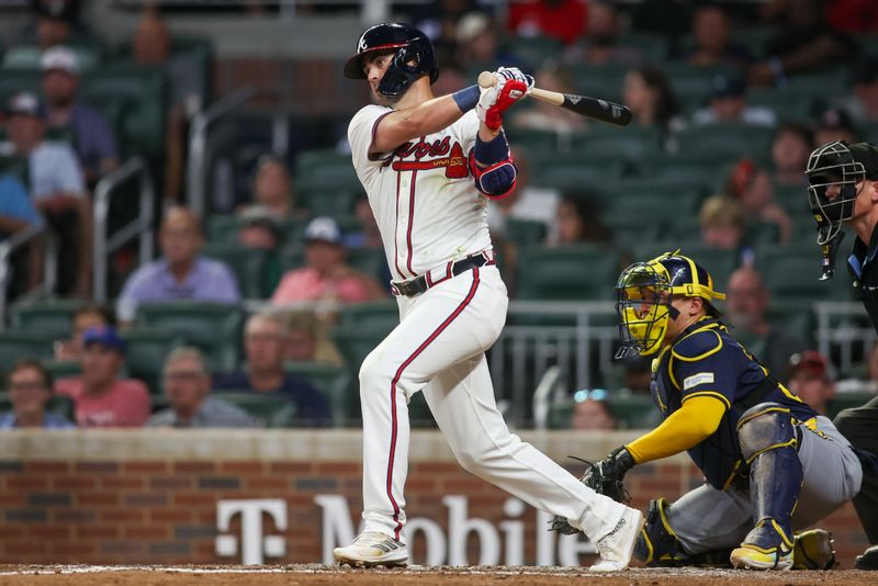 Aug 7, 2024; Atlanta, Georgia, USA; Atlanta Braves second baseman Whit Merrifield (15) hits a single against the Milwaukee Brewers in the fifth inning at Truist Park. Mandatory Credit: Brett Davis-USA TODAY Sports
