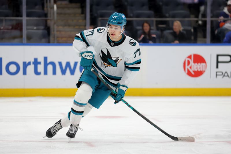 Oct 21, 2025; Elmont, New York, USA; San Jose Sharks center Michael Misa (77) skates against the New York Islanders during the third period at UBS Arena. Mandatory Credit: Brad Penner-Imagn Images