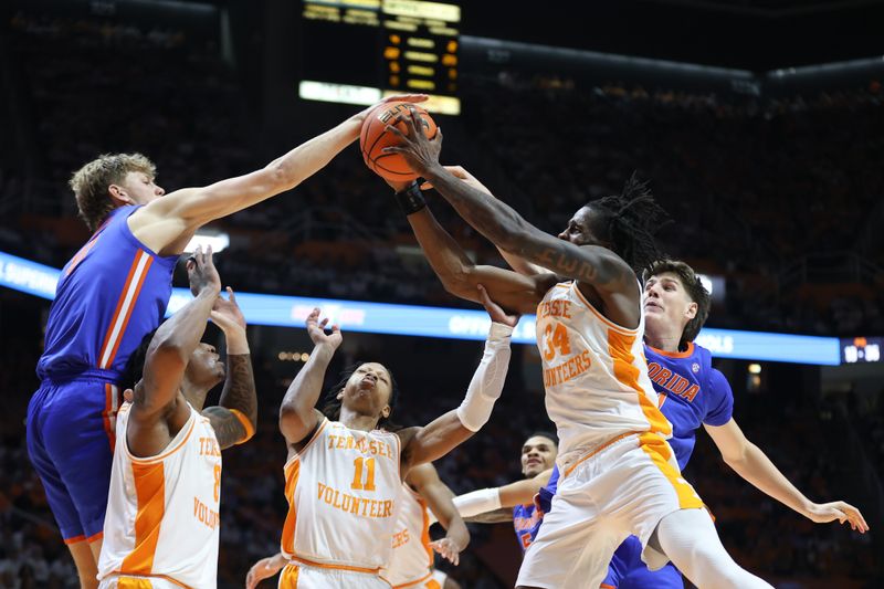 Feb 1, 2025; Knoxville, Tennessee, USA; Tennessee Volunteers forward Felix Okpara (34) rebounds the ball against the Florida Gators during the second half at Thompson-Boling Arena at Food City Center. Mandatory Credit: Randy Sartin-Imagn Images