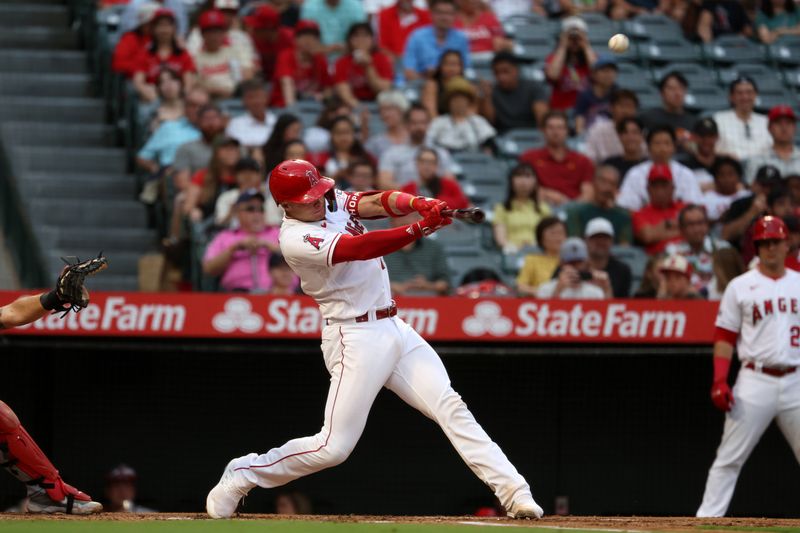 Sep 9, 2023; Anaheim, California, USA;  Los Angeles Angels catcher Logan O'Hoppe (14) hits a two-run home run during the first inning against the Cleveland Guardians at Angel Stadium. Mandatory Credit: Kiyoshi Mio-USA TODAY Sports