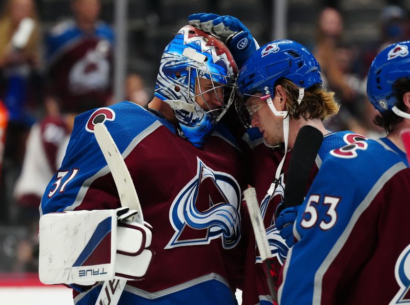 Sep 25, 2022; Denver, Colorado, USA; Colorado Avalanche defenseman Bowen Byram (4) and goaltender Jonas Johansson (31) celebrate defeating the Vegas Golden Knights at Ball Arena. Mandatory Credit: Ron Chenoy-USA TODAY Sports