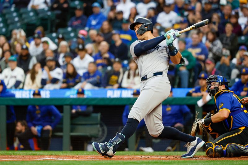 Sep 17, 2024; Seattle, Washington, USA; New York Yankees designated hitter Aaron Judge (99) hits a two-run double against the Seattle Mariners during the first inning at T-Mobile Park. Mandatory Credit: Joe Nicholson-Imagn Images