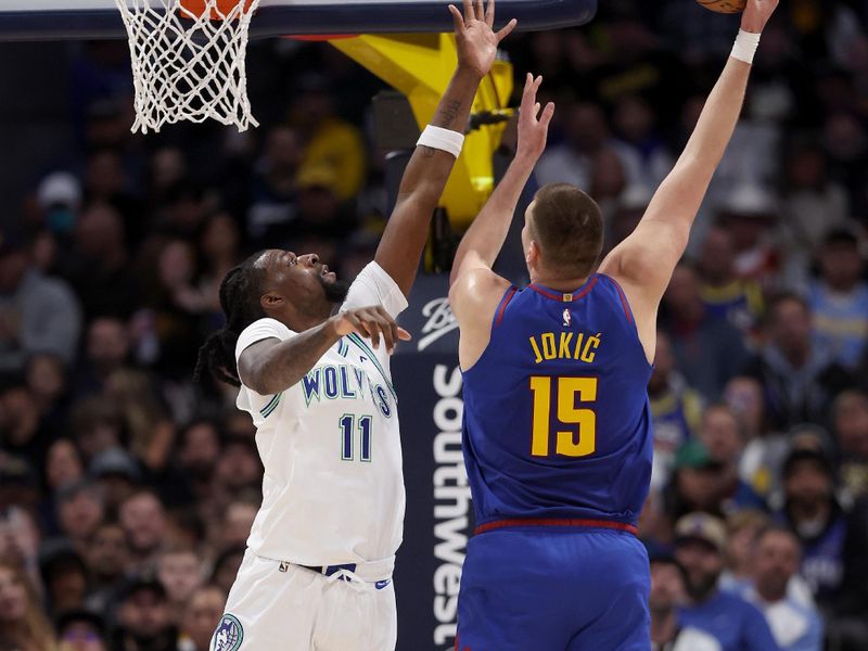 DENVER, COLORADO - MARCH 29: Nikola Jokic #15 of the Denver Nuggets puts up a shot over Naz Reid #11 of the Minnesota Timberwolves during the first quarter at Ball Arena on March 29, 2024 in Denver, Colorado. NOTE TO USER: User expressly acknowledges and agrees that, by downloading and or using this photograph, User is consenting to the terms and conditions of the Getty Images License Agreement.  (Photo by Matthew Stockman/Getty Images)