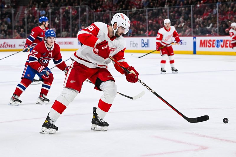 Dec 2, 2023; Montreal, Quebec, CAN; Detroit Red Wings defenseman Jake Walman (96) plays the puck against the Montreal Canadiens during the third period at Bell Centre. Mandatory Credit: David Kirouac-USA TODAY Sports