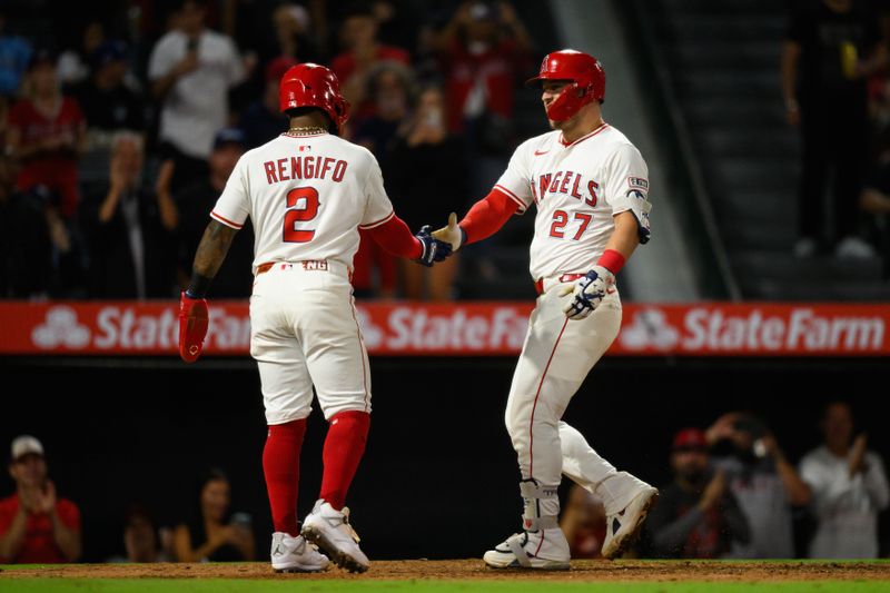 Sep 25, 2025; Anaheim, California, USA; Los Angeles Angels designated hitter Mike Trout (27), right, is greeted by third baseman Luis Rengifo (2) after hitting a home run during the eighth inning against the Kansas City Royals at Angel Stadium. Mandatory Credit: William Liang-Imagn Images