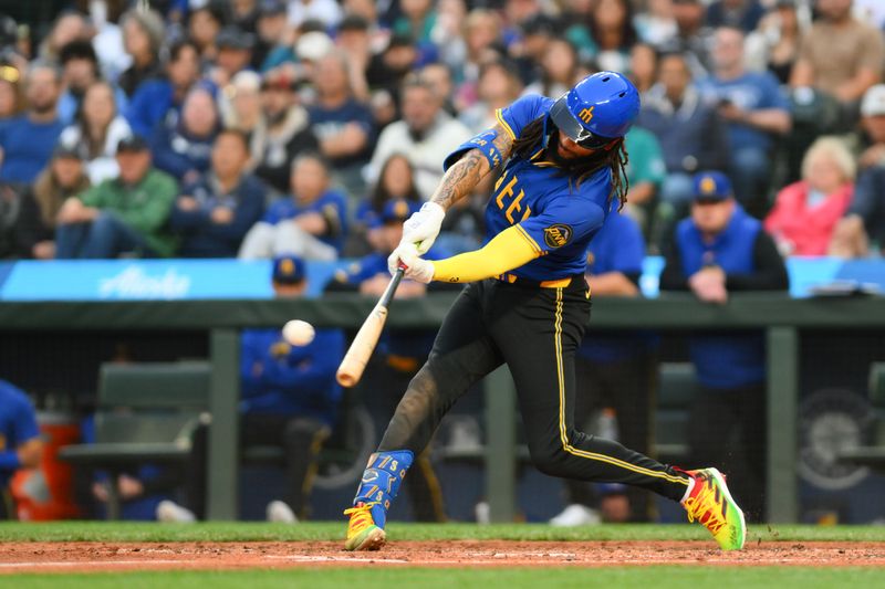 May 31, 2024; Seattle, Washington, USA; Seattle Mariners shortstop J.P. Crawford (3) hits a double against the Los Angeles Angels during the fifth inning at T-Mobile Park. Mandatory Credit: Steven Bisig-USA TODAY Sports