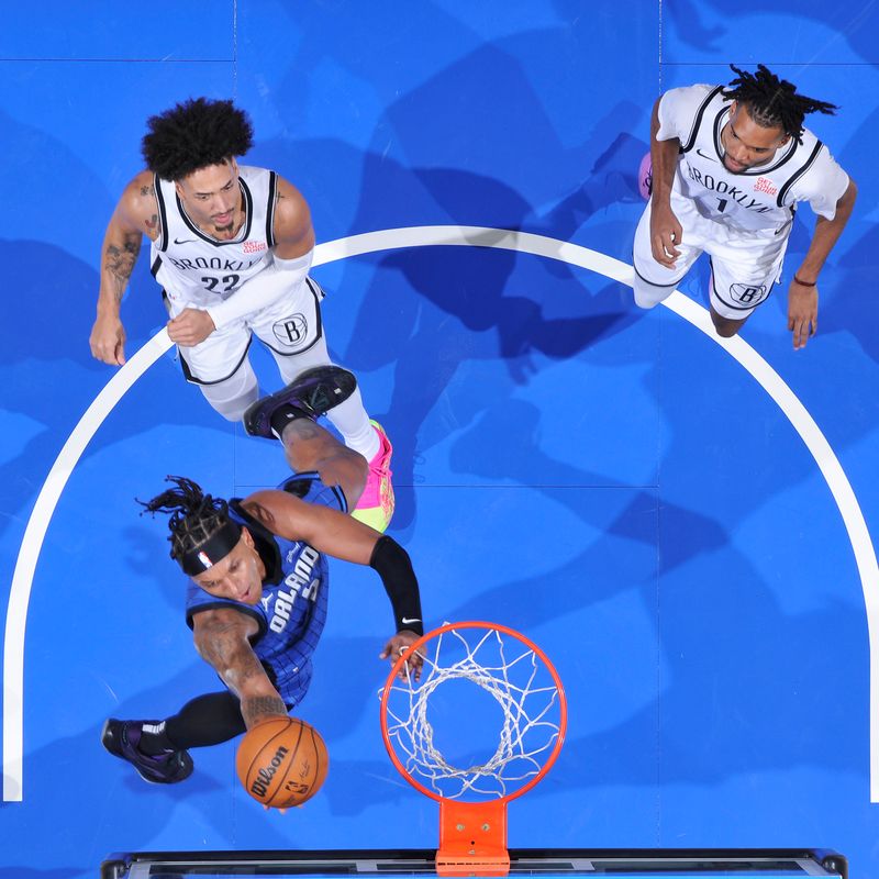 ORLANDO, FL - OCTOBER 25: Paolo Banchero #5 of the Orlando Magic drives to the basket during the game against the Brooklyn Nets on October 25, 2024 at Kia Center in Orlando, Florida. NOTE TO USER: User expressly acknowledges and agrees that, by downloading and or using this photograph, User is consenting to the terms and conditions of the Getty Images License Agreement. Mandatory Copyright Notice: Copyright 2024 NBAE (Photo by Fernando Medina/NBAE via Getty Images)
