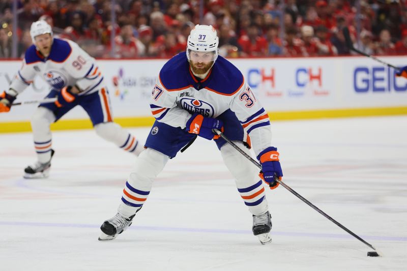 Jun 24, 2024; Sunrise, Florida, USA; Edmonton Oilers forward Warren Foegele (37) controls the puck  during the third period against the Florida Panthers in game seven of the 2024 Stanley Cup Final at Amerant Bank Arena. Mandatory Credit: Sam Navarro-USA TODAY Sports