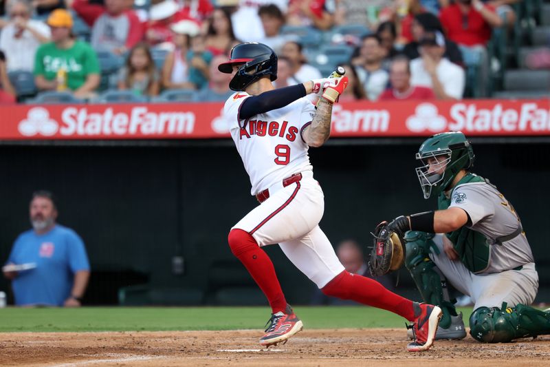 Jul 25, 2024; Anaheim, California, USA;  Los Angeles Angels shortstop Zach Neto (9) hits an RBI single during the second inning against the Oakland Athletics at Angel Stadium. Mandatory Credit: Kiyoshi Mio-USA TODAY Sports