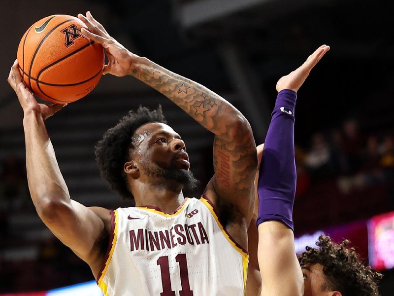 Feb 25, 2025; Minneapolis, Minnesota, USA; Minnesota Golden Gophers guard Femi Odukale (11) shoots as Northwestern Wildcats guard Ty Berry (3) defends during the first half at Williams Arena. Mandatory Credit: Matt Krohn-Imagn Images