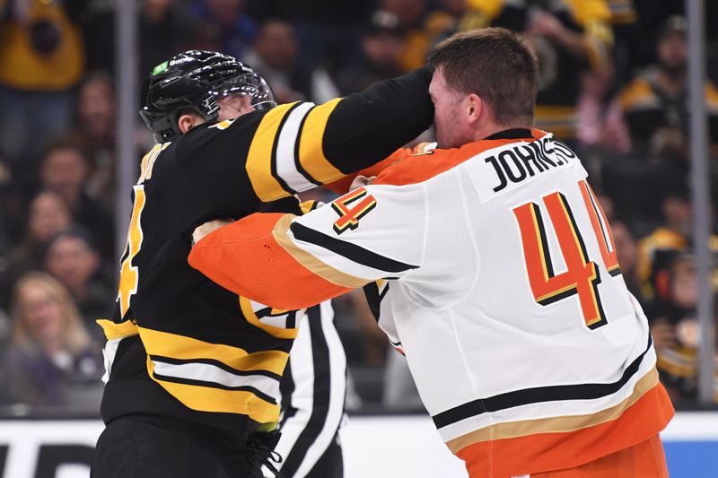 Oct 23, 2025; Boston, Massachusetts, USA; Boston Bruins left wing Tanner Jeannot (84) fights with Anaheim Ducks left wing Ross Johnston (44) during the second period at TD Garden. Mandatory Credit: Bob DeChiara-Imagn Images