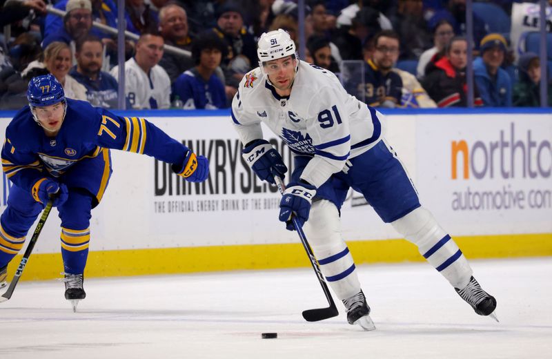 Dec 21, 2023; Buffalo, New York, USA;  Toronto Maple Leafs center John Tavares (91) skates up ice with the puck during the third period against the Buffalo Sabres at KeyBank Center. Mandatory Credit: Timothy T. Ludwig-USA TODAY Sports