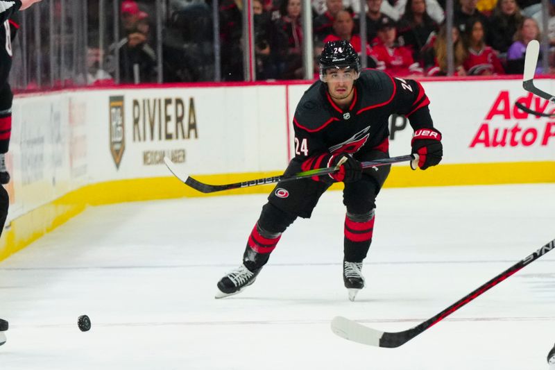 Oct 27, 2023; Raleigh, North Carolina, USA; Carolina Hurricanes center Seth Jarvis (24) skates after the puck against the San Jose Sharks during the second period at PNC Arena. Mandatory Credit: James Guillory-USA TODAY Sports