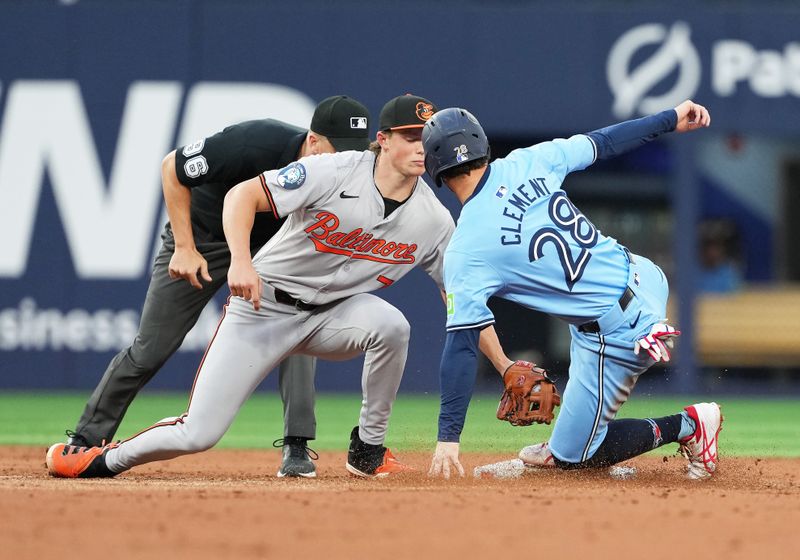 Aug 7, 2024; Toronto, Ontario, CAN; Toronto Blue Jays second baseman Ernie Clement (28) is tagged out at second base by Baltimore Orioles shortstop Gunnar Henderson (2) during the second inning at Rogers Centre. Mandatory Credit: Nick Turchiaro-USA TODAY Sports