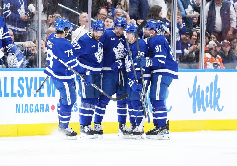 Feb 15, 2024; Toronto, Ontario, CAN; Toronto Maple Leafs center Auston Matthews (34) scores his first goal and celebrates with right wing Mitchell Marner (16) against the Philadelphia Flyers during the second period at Scotiabank Arena. Mandatory Credit: Nick Turchiaro-USA TODAY Sports