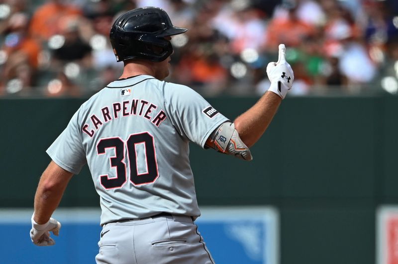 Sep 22, 2024; Baltimore, Maryland, USA;  Detroit Tigers outfielder Kerry Carpenter (30) signals home run at second base during the sixth inning against the Baltimore Orioles at Oriole Park at Camden Yards. Mandatory Credit: Tommy Gilligan-Imagn Images