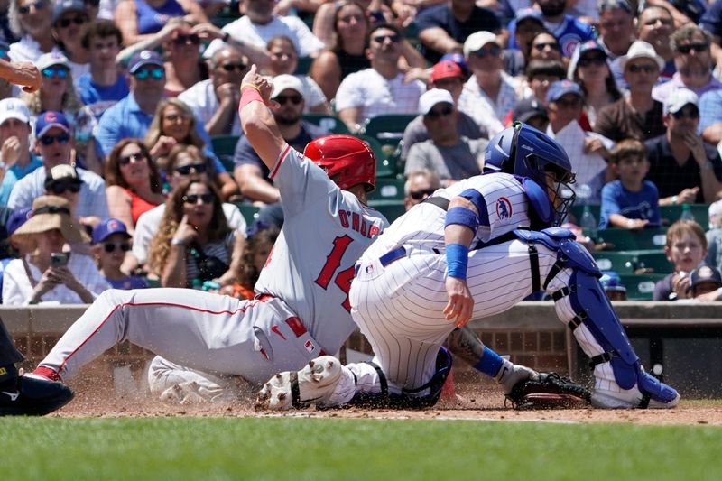 Jul 6, 2024; Chicago, Illinois, USA; Los Angeles Angels catcher Logan O'Hoppe (14) is safe at home plate as Chicago Cubs catcher Tomás Nido (6) takes a throw during the third inning at Wrigley Field. Mandatory Credit: David Banks-USA TODAY Sports