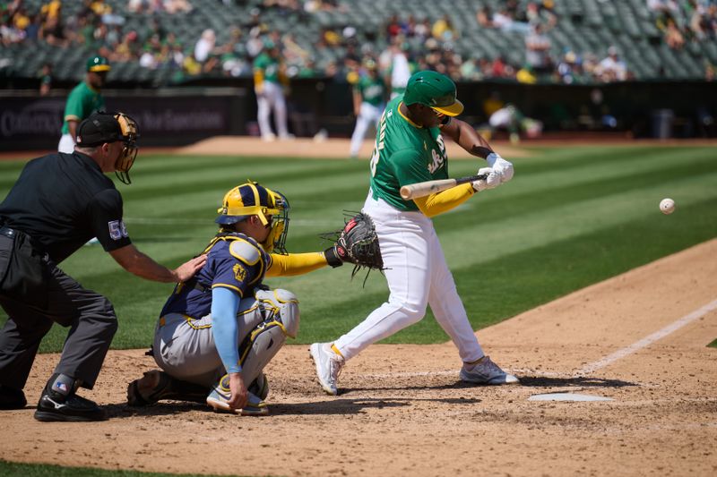 Aug 24, 2024; Oakland, California, USA; Oakland Athletics outfielder Daz Cameron (28) hits an RBI double against the Milwaukee Brewers during the seventh inning at Oakland-Alameda County Coliseum. Mandatory Credit: Robert Edwards-USA TODAY Sports