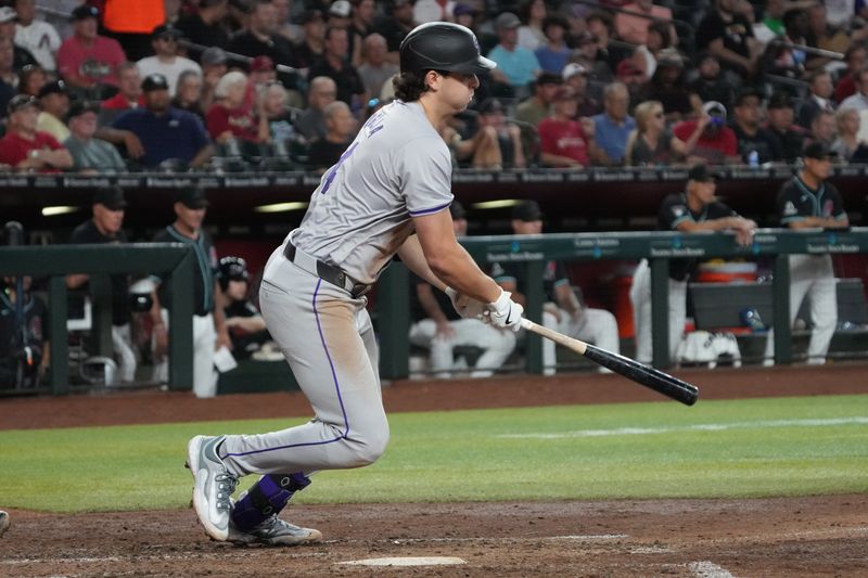 Aug 14, 2024; Phoenix, Arizona, USA; Colorado Rockies first base Michael Toglia (4) grounds in to a fielders choice to drive in a run against the Arizona Diamondbacks in the fourth inning at Chase Field. Mandatory Credit: Rick Scuteri-USA TODAY Sports