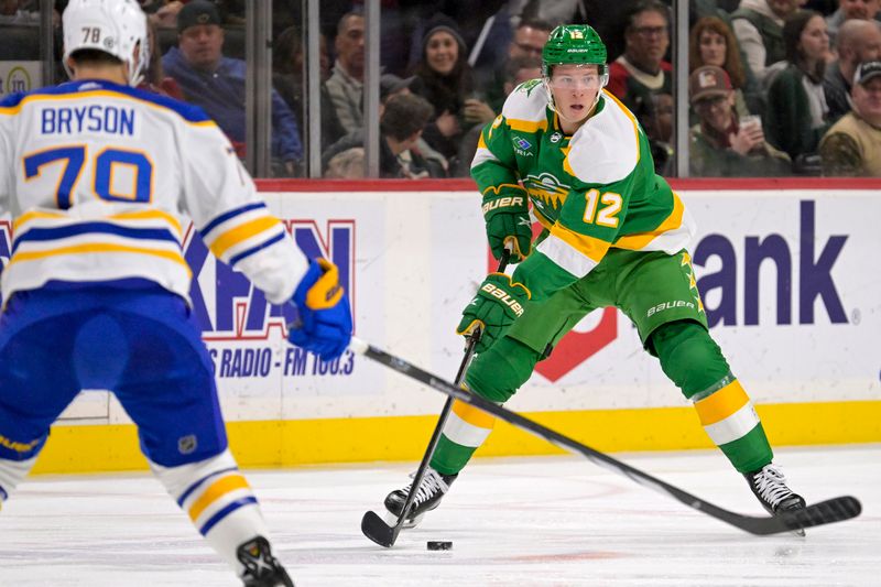 Feb 17, 2024; Saint Paul, Minnesota, USA;  Minnesota Wild forward Matt Boldy (12) controls the puck against the Buffalo Sabres during the second period at Xcel Energy Center. Mandatory Credit: Nick Wosika-USA TODAY Sports