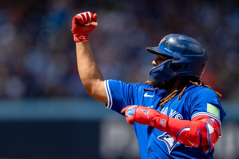 Aug 13, 2023; Toronto, Ontario, CAN; Toronto Blue Jays first baseman Vladimir Guerrero Jr. (27) celebrates after hitting a RBI single against the Chicago Cubs during the second inning at Rogers Centre. Mandatory Credit: Kevin Sousa-USA TODAY Sports