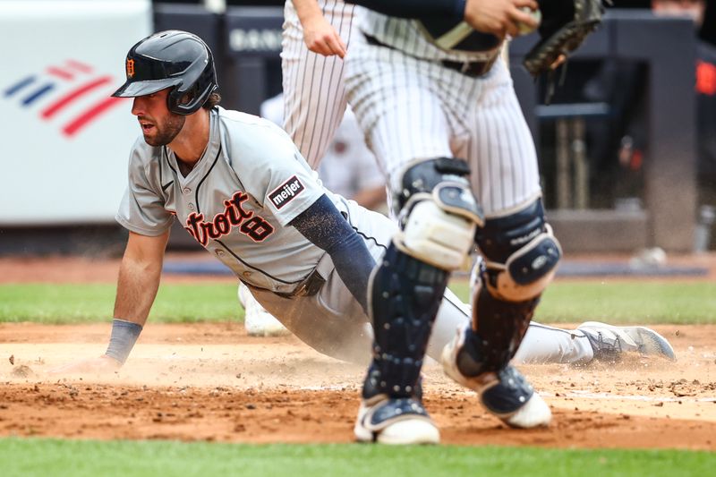 May 4, 2024; Bronx, New York, USA;  Detroit Tigers third baseman Matt Vierling (8) slides into home plate scoring a run in the fourth inning against the New York Yankees at Yankee Stadium. Mandatory Credit: Wendell Cruz-USA TODAY Sports