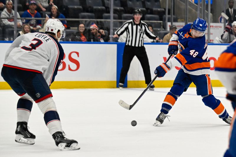 Nov 2, 2025; Elmont, New York, USA;  New York Islanders defenseman Matthew Schaefer (48) attempts a shot defended by Columbus Blue Jackets center Charlie Coyle (3) during the third period at UBS Arena. Mandatory Credit: Dennis Schneidler-Imagn Images