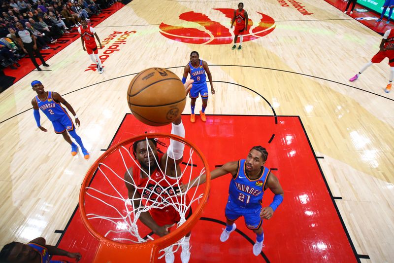 TORONTO, CANADA - DECEMBER 05: Bruno Fernando #24 of the Toronto Raptors shoots the ball during the game against the Oklahoma City Thunder on December 5, 2024 at the Scotiabank Arena in Toronto, Ontario, Canada.  NOTE TO USER: User expressly acknowledges and agrees that, by downloading and or using this Photograph, user is consenting to the terms and conditions of the Getty Images License Agreement.  Mandatory Copyright Notice: Copyright 2024 NBAE (Photo by Vaughn Ridley/NBAE via Getty Images)