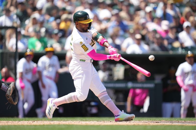 May 11, 2025; West Sacramento, California, USA; Athletics right fielder Miguel Andujar (22) hits an RBI single against the New York Yankees in the fourth inning at Sutter Health Park. Mandatory Credit: Cary Edmondson-Imagn Images