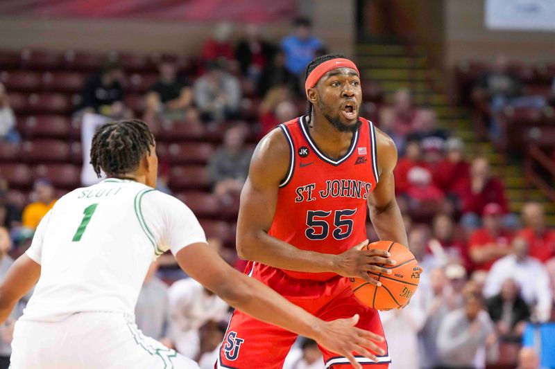 Nov 16, 2023; Charleston, South Carolina, USA; St. John's Red Storm forward Drissa Traore (55) is guarded by North Texas Mean Green forward Aaron Scott (1) in the second half at TD Arena. Mandatory Credit: David Yeazell-USA TODAY Sports