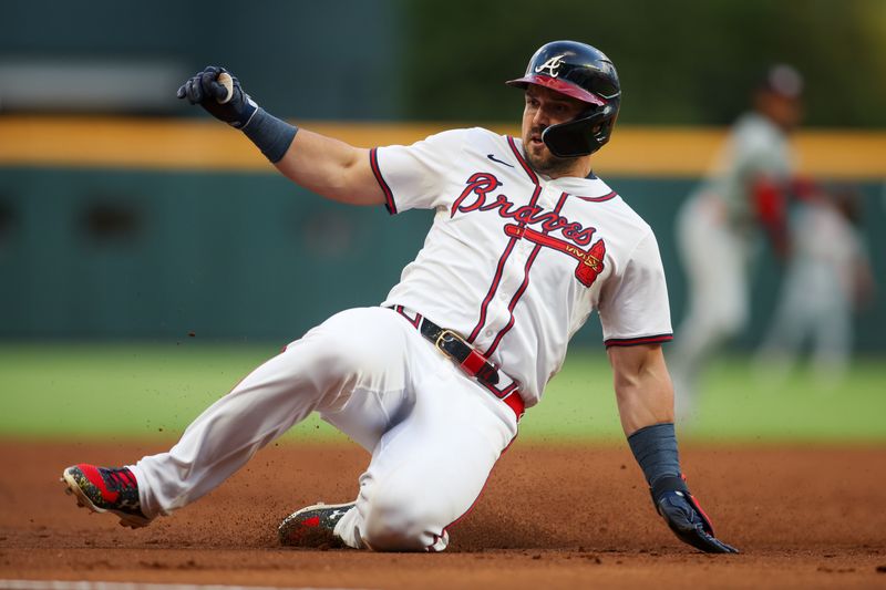 May 28, 2024; Atlanta, Georgia, USA; Atlanta Braves right fielder Adam Duvall (14) slides safely into third against the Washington Nationals in the third inning at Truist Park. Mandatory Credit: Brett Davis-USA TODAY Sports