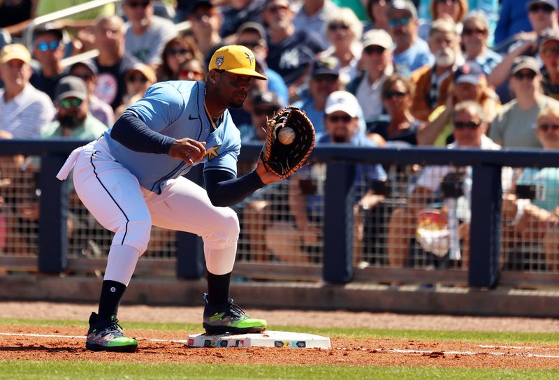 Feb 27, 2024; Port Charlotte, Florida, USA; Tampa Bay Rays first baseman Yandy Diaz (2) catches the ball for an out during the first inning at Charlotte Sports Park. Mandatory Credit: Kim Klement Neitzel-USA TODAY Sports