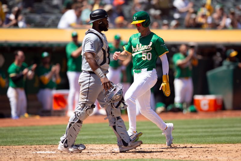 Aug 7, 2024; Oakland, California, USA; Oakland Athletics first baseman Armando Alvarez (50) scores the go-ahead run against Chicago White Sox catcher Chuckie Robinson (47) during the seventh inning at Oakland-Alameda County Coliseum. Mandatory Credit: D. Ross Cameron-USA TODAY Sports