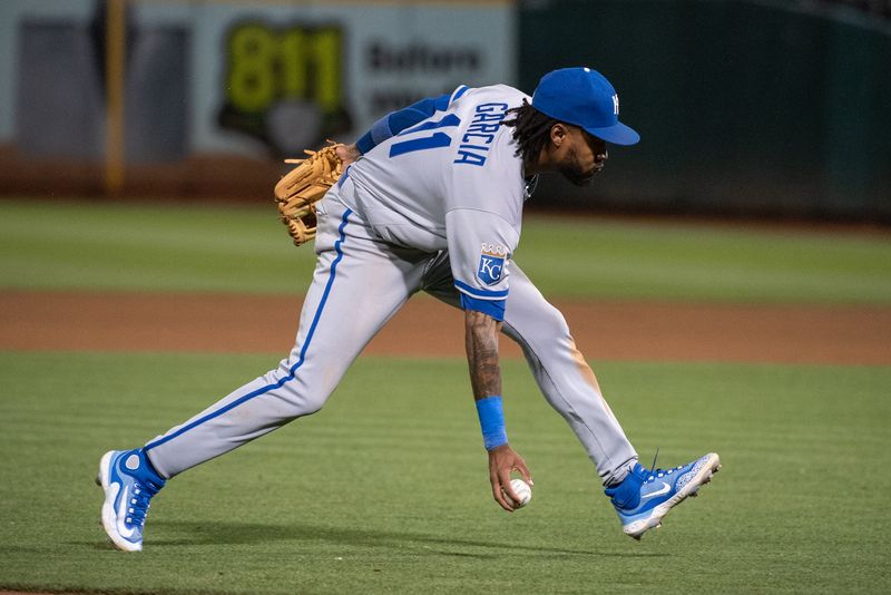 Aug 22, 2023; Oakland, California, USA; Kansas City Royals third baseman Maikel Garcia (11) fields a ground ball bare handed during the sixth inning against the Oakland Athletics at Oakland-Alameda County Coliseum. Mandatory Credit: Ed Szczepanski-USA TODAY Sports