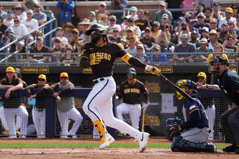 Feb 24, 2024; Peoria, Arizona, USA; San Diego Padres right fielder Fernando Tatis Jr. (23) bats against the Milwaukee Brewers during the first inning of a Spring Training game at Peoria Sports Complex. Mandatory Credit: Joe Camporeale-USA TODAY Sports