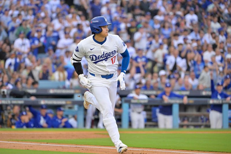 Oct 20, 2024; Los Angeles, California, USA; Los Angeles Dodgers designated hitter Shohei Ohtani (17) runs to first after hitting a single in the first inning against the New York Mets during game six of the NLCS for the 2024 MLB playoffs at Dodger Stadium. Mandatory Credit: Jayne Kamin-Oncea-Imagn Images