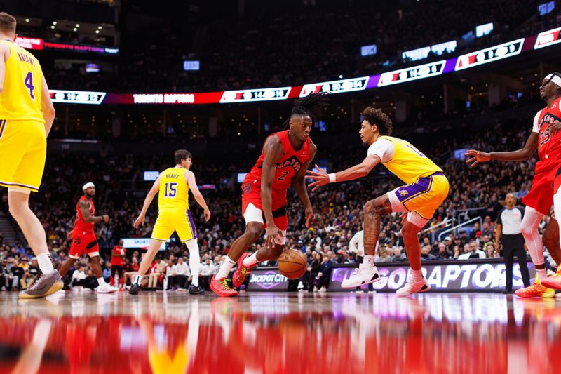 TORONTO, CANADA - NOVEMBER 1: Jonathan Mogbo #2 of the Toronto Raptors drives against Jaxson Hayes #11 of the Los Angeles Lakers during the second half of their NBA game at Scotiabank Arena on November 1, 2024 in Toronto, Canada. NOTE TO USER: User expressly acknowledges and agrees that, by downloading and or using this photograph, User is consenting to the terms and conditions of the Getty Images License Agreement. (Photo by Cole Burston/Getty Images)