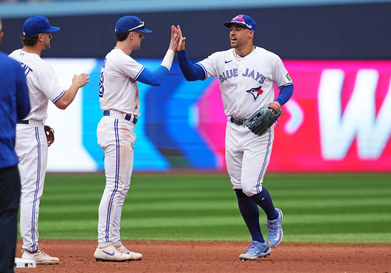 Sep 9, 2023; Toronto, Ontario, CAN; Toronto Blue Jays right fielder George Springer (4) celebrates the win with third baseman Cavan Biggio (8) against the Kansas City Royals at the end of the ninth inning at Rogers Centre. Mandatory Credit: Nick Turchiaro-USA TODAY Sports