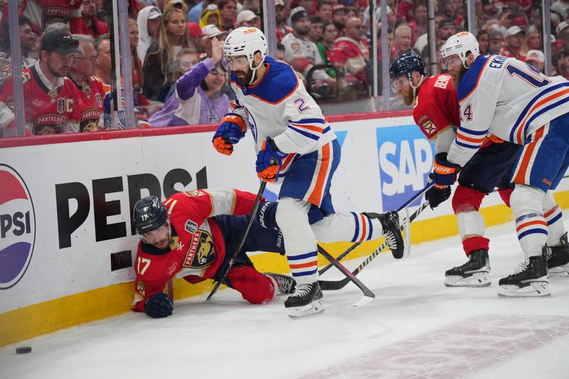 Jun 24, 2024; Sunrise, Florida, USA; Florida Panthers forward Evan Rodrigues (17) battles for the puck against Edmonton Oilers defenseman Evan Bouchard (2) during the second period in game seven of the 2024 Stanley Cup Final at Amerant Bank Arena. Mandatory Credit: Jim Rassol-USA TODAY Sports