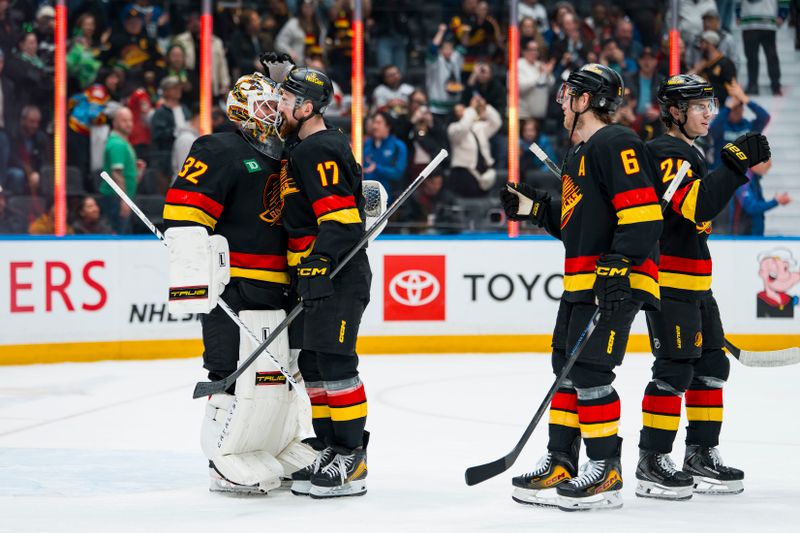 Mar 17, 2026; Vancouver, British Columbia, CAN; Vancouver Canucks goalie Kevin Lankinen (32), defenseman Filip Hronek (17), forward Brock Boeser (6) and defenseman Zeev Buium (24) celebrate their victory against the Florida Panthers at Rogers Arena. Mandatory Credit: Bob Frid-Imagn Images