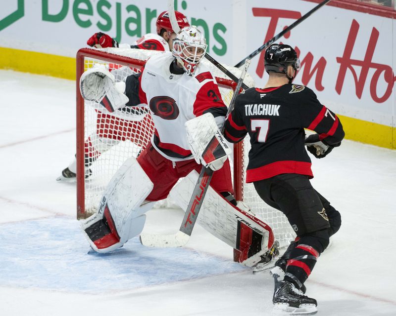 Jan 24, 2026; Ottawa, Ontario, CAN; Carolina Hurricanes goalie Brandon Bussi (32) follows the puck as  Ottawa Senators left wing Brady Tkachuk (7) skates past in the third period at the Canadian Tire Centre. Mandatory Credit: Marc DesRosiers-IMAGN Images