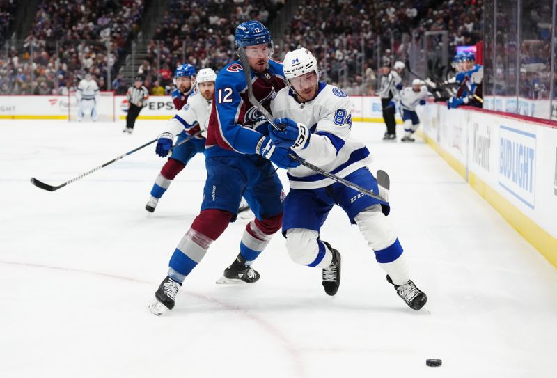 Nov 27, 2023; Denver, Colorado, USA; Colorado Avalanche center Ryan Johansen (12) hits Tampa Bay Lightning left wing Tanner Jeannot (84) in the first period at Ball Arena. Mandatory Credit: Ron Chenoy-USA TODAY Sports