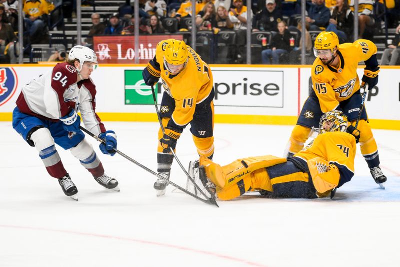 Nov 2, 2024; Nashville, Tennessee, USA;  Nashville Predators goaltender Juuse Saros (74) and center Gustav Nyquist (14) blocks the shot of Colorado Avalanche left wing Joel Kiviranta (94) during the second period at Bridgestone Arena. Mandatory Credit: Steve Roberts-Imagn Images