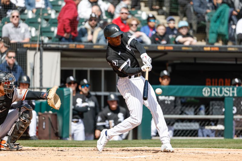 Apr 6, 2023; Chicago, Illinois, USA; Chicago White Sox shortstop Tim Anderson (7) hits a two-run RBI single against the San Francisco Giants during the second inning at Guaranteed Rate Field. Mandatory Credit: Kamil Krzaczynski-USA TODAY Sports