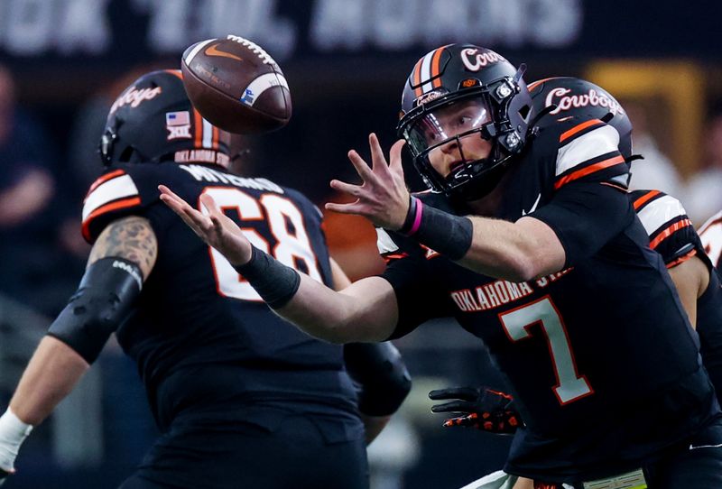 Dec 2, 2023; Arlington, TX, USA;  Oklahoma State Cowboys quarterback Alan Bowman (7) fields a fumbled snapo during the second half against the Texas Longhorns at AT&T Stadium. Mandatory Credit: Kevin Jairaj-USA TODAY Sports