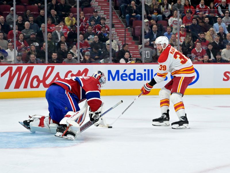 Nov 5, 2024; Montreal, Quebec, CAN; Montreal Canadiens goalie Sam Montembeault (35) stops Calgary Flames forward Anthony Mantha (39) during the first period at the Bell Centre. Mandatory Credit: Eric Bolte-Imagn Images